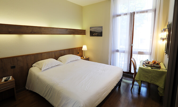 View of the Hôtel Belleville's premium room with double bed, offering a bright, welcoming space